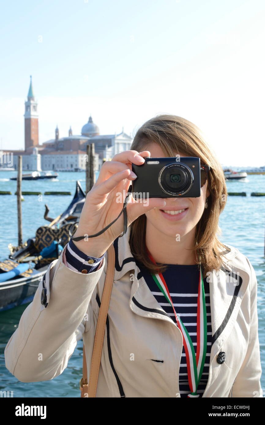 Young woman taking a selfie photo on camera in Venice Stock Photo