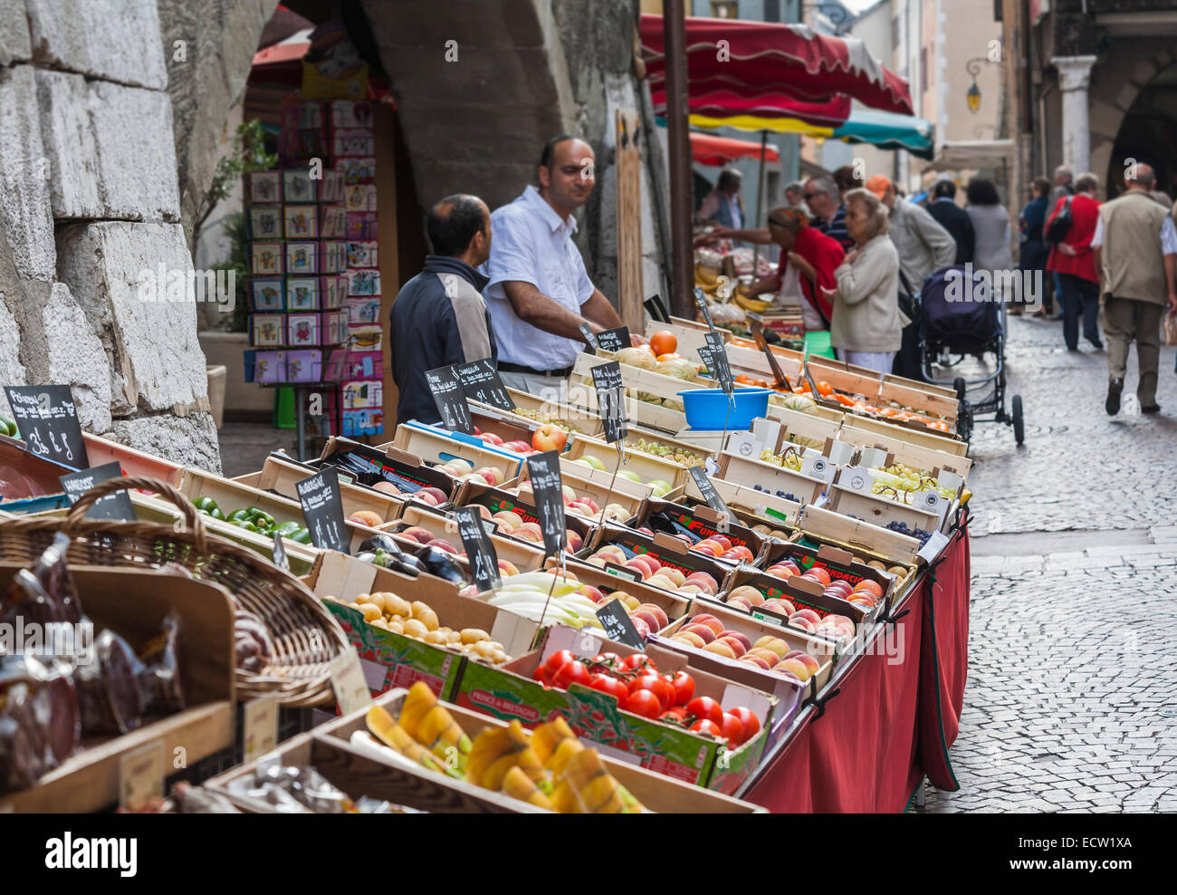 Local lifestyle: Fruit, vegetable and produce stalls and stallholders at the popular local outdoor food market in the old town, Annecy, France Stock Photo