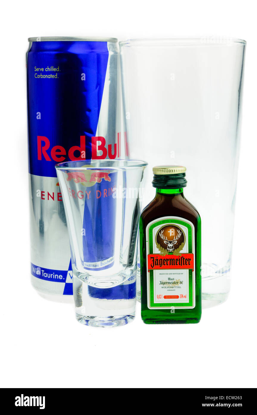 Preparing to make a Jagerbomb, made by dropping a shot glass of Jagermeister into a large glass of Red Bull energy drink. Stock Photo