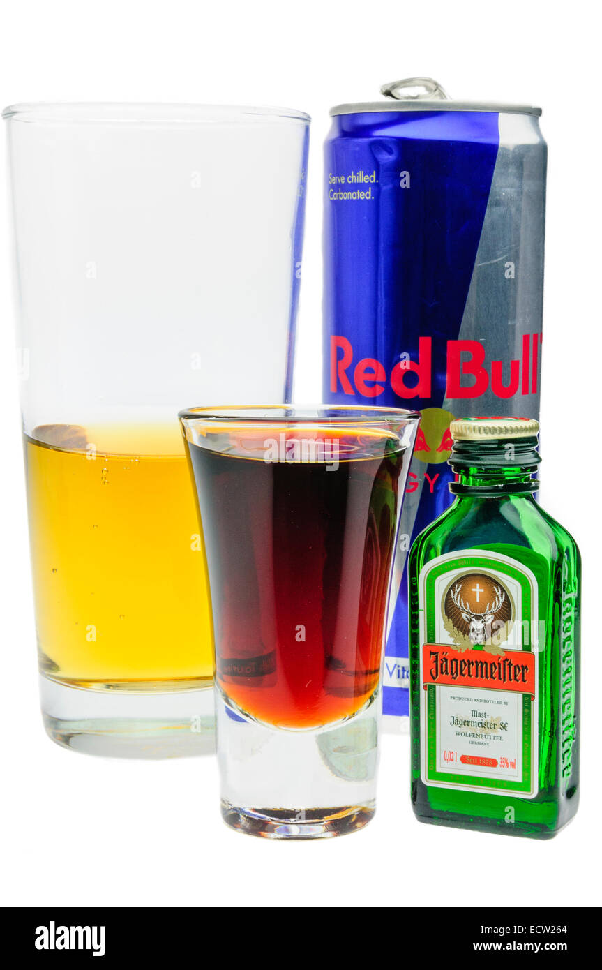 All the elements of a Jagerbomb, made by dropping a shot glass of Jagermeister into a large glass of Red Bull energy drink. Stock Photo