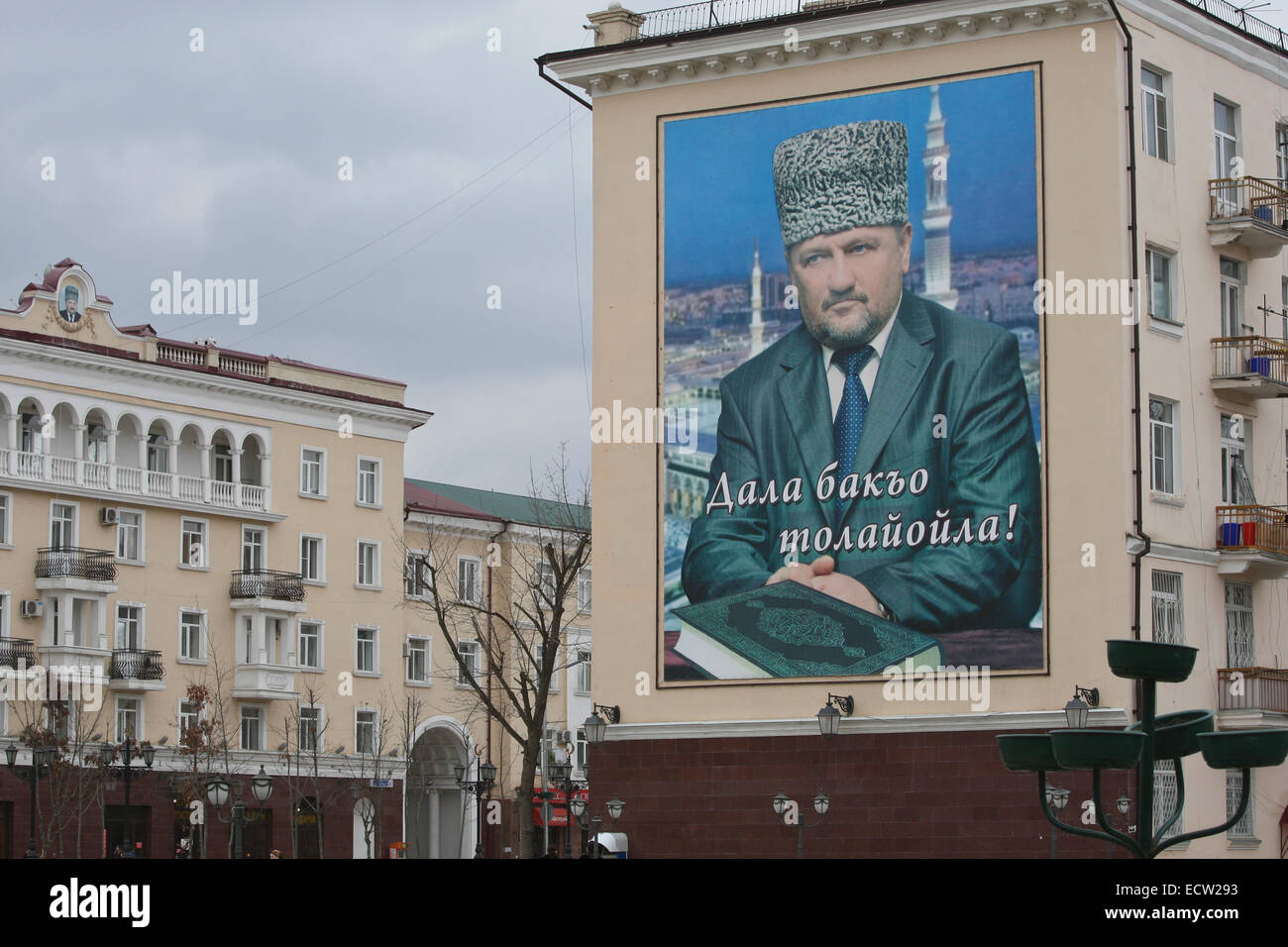 A huge portrait of former Chechen president Akhmat-Khadzhi Kadyrov on a building in Putin Avenue, the former Victory Avenue, in the centre of the Chechen capital Grozny, Russia. It is the main street of Grozny and has undergone a true metamorphose in recent years, following almost total destruction during two wars. Stock Photo