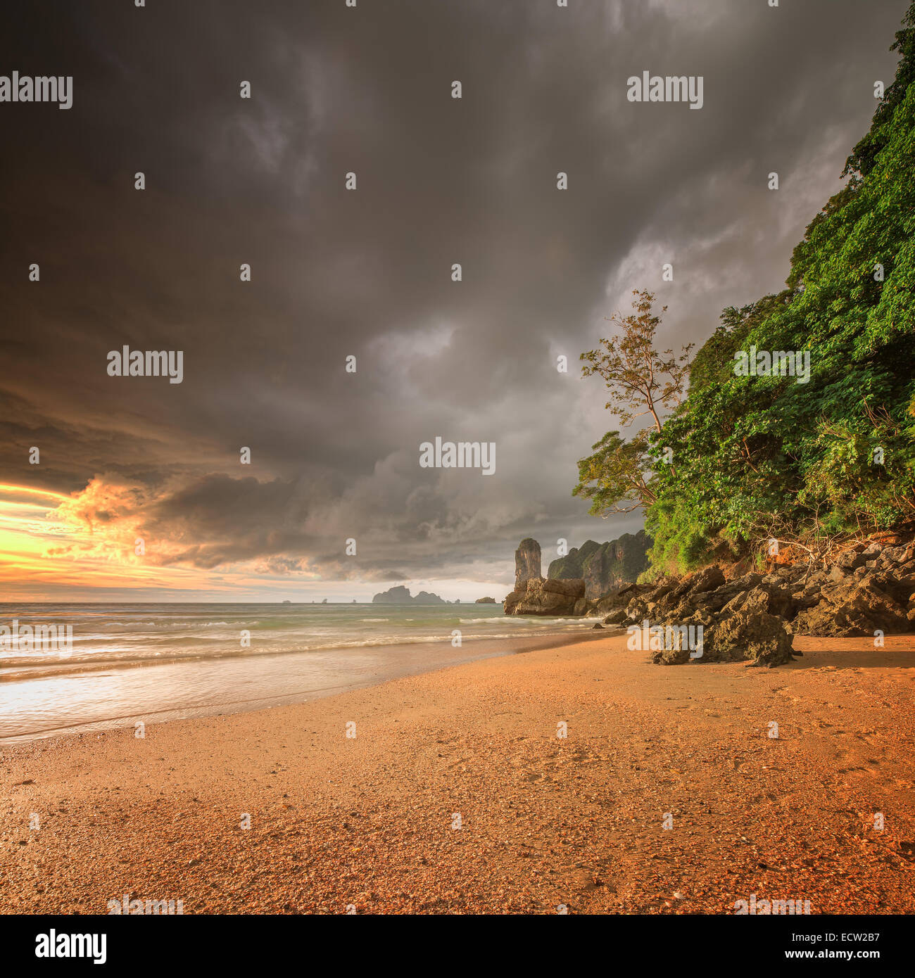 Dramatic sunset rays through a cloudy dark sky and mountains over the ...