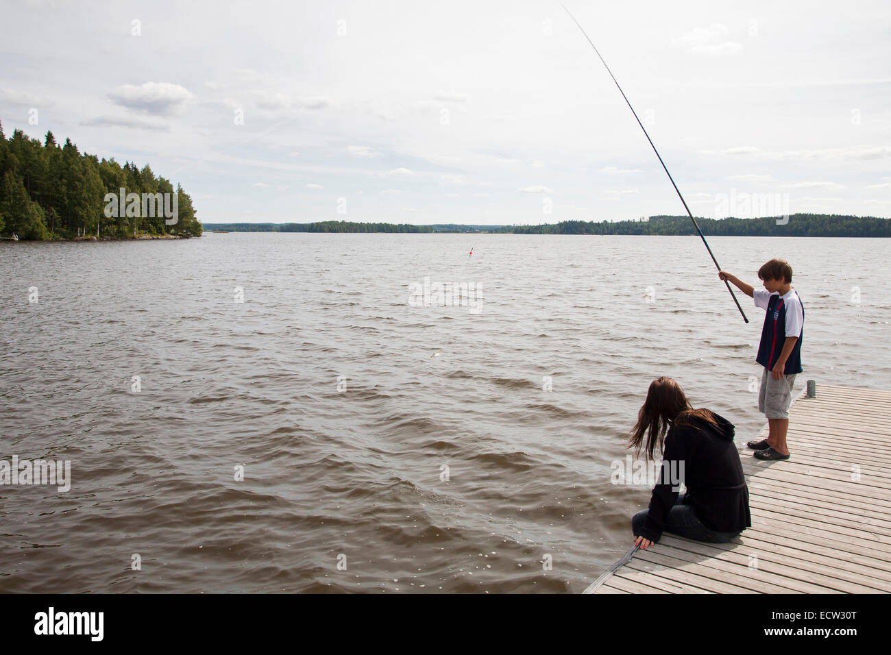 boy fishing, rautavesi lake, vammala village area, finland, europe Stock Photo