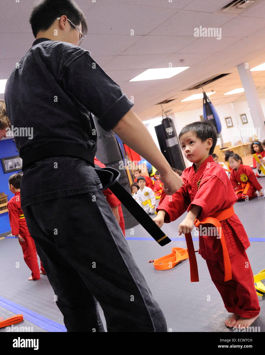 Toronto, Canada. 19th December 2014. 4 year old Brendan Chan attends a Karate Belt Graduation where he receives his Orange Belt. Brendan has been attending Karate training for 6 months. Credit:  EXImages/Alamy Live News Stock Photo