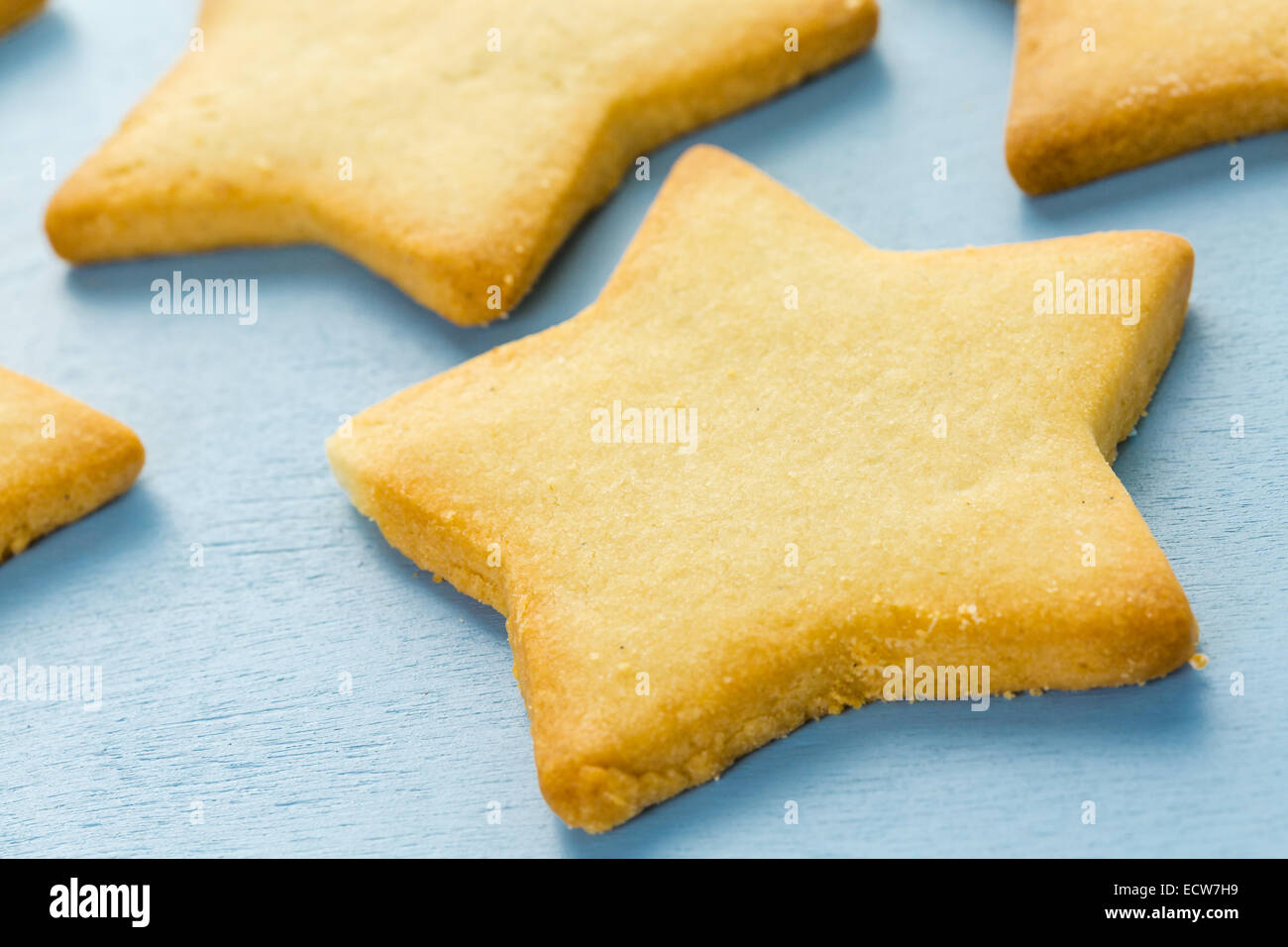 Sugar cookies in shape eof stars on blue background. Stock Photo