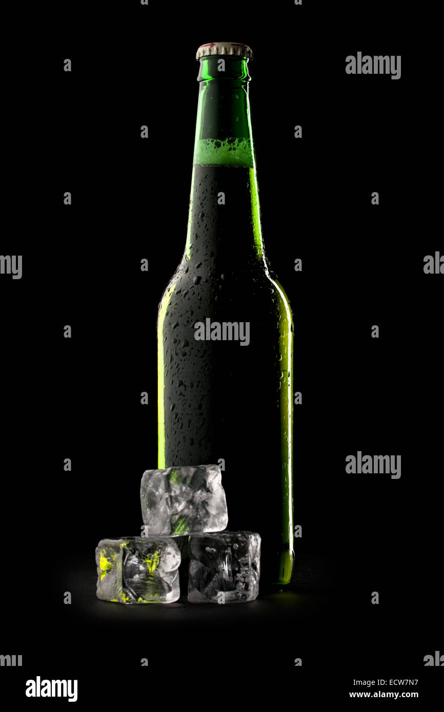 Bottle of beer with ice cubes Stock Photo