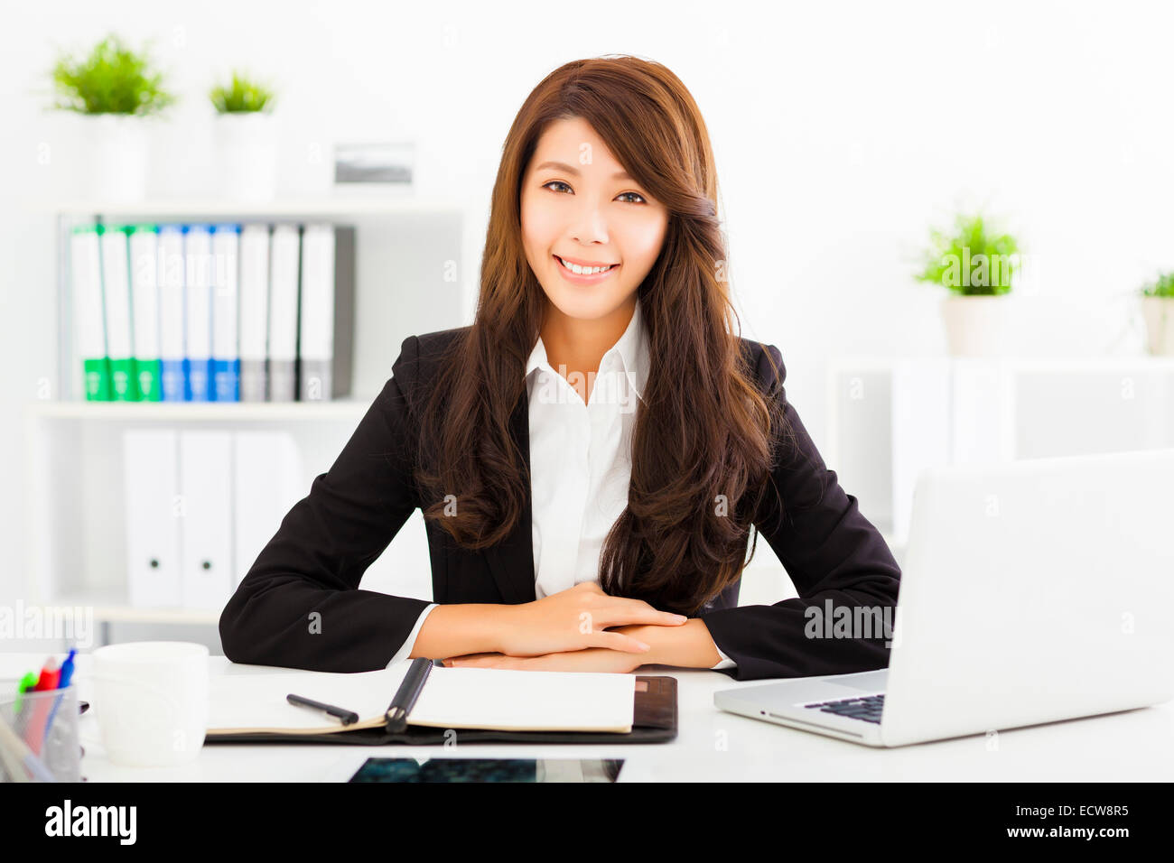 smiling young business woman working in the office Stock Photo - Alamy