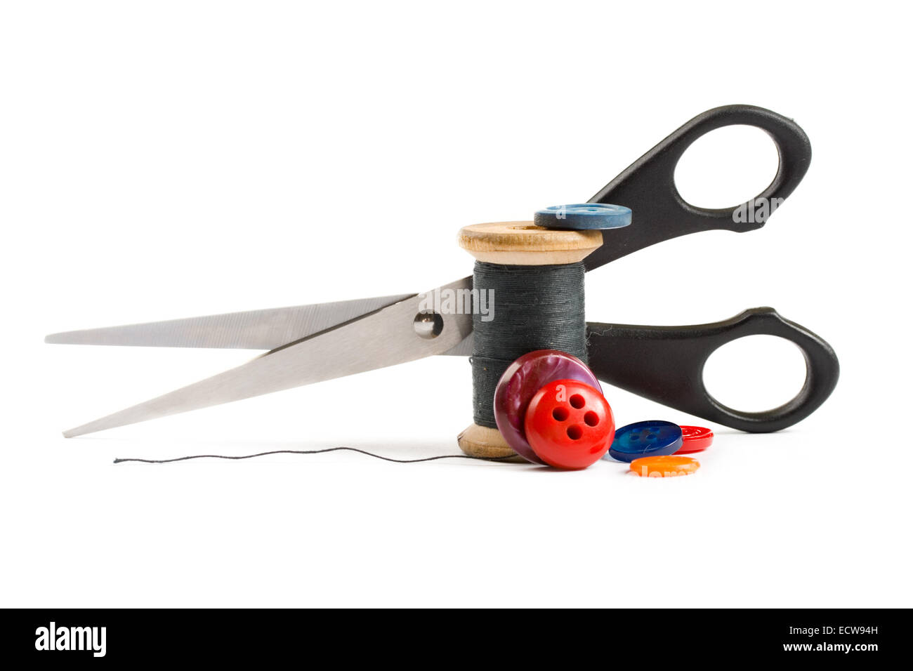 Thread bobbin, scissors and buttons isolated on white background Stock Photo