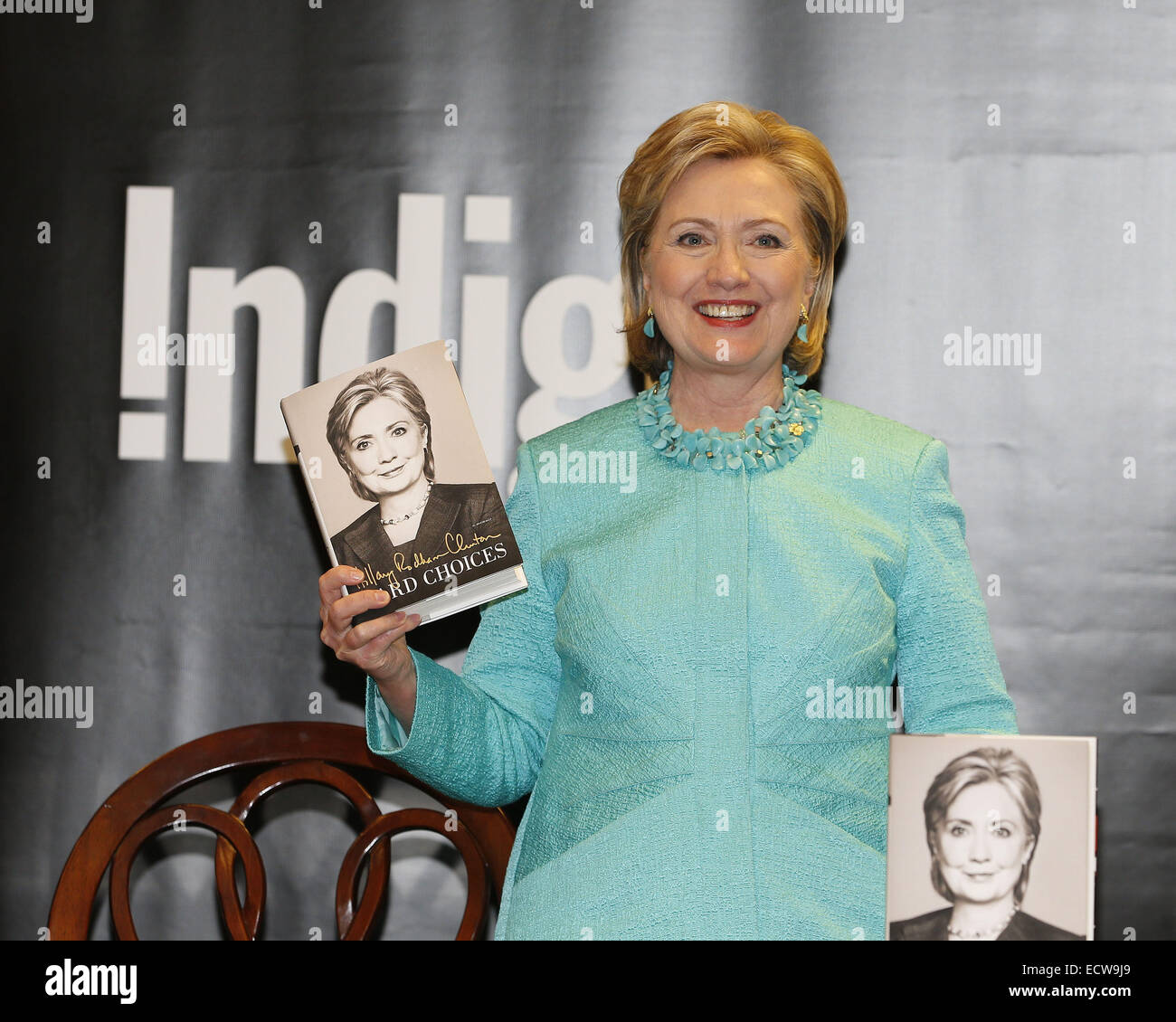 Former U.S. Secretary of State and First Lady Hillary Clinton signs ...
