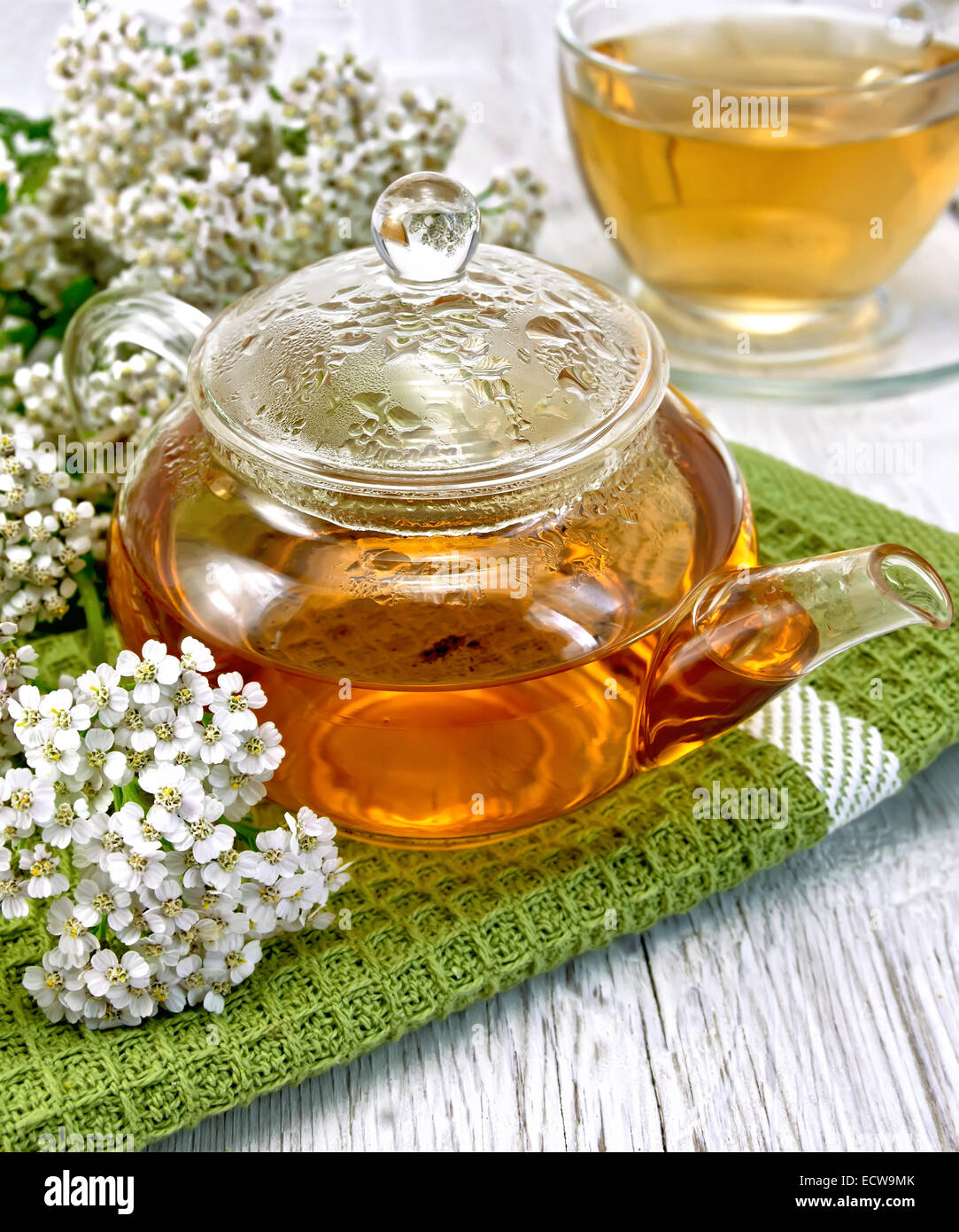 Tea with yarrow in glass teapot on board Stock Photo Alamy