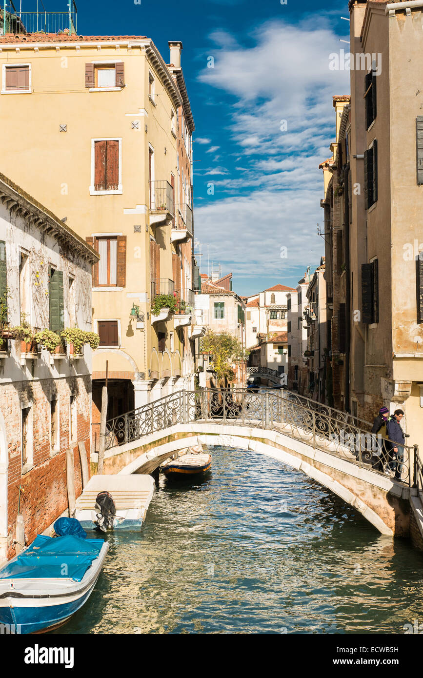 The agitated water of a canal (on the island of Venice, Italy) indicates a motor boat has passed this way. Stock Photo