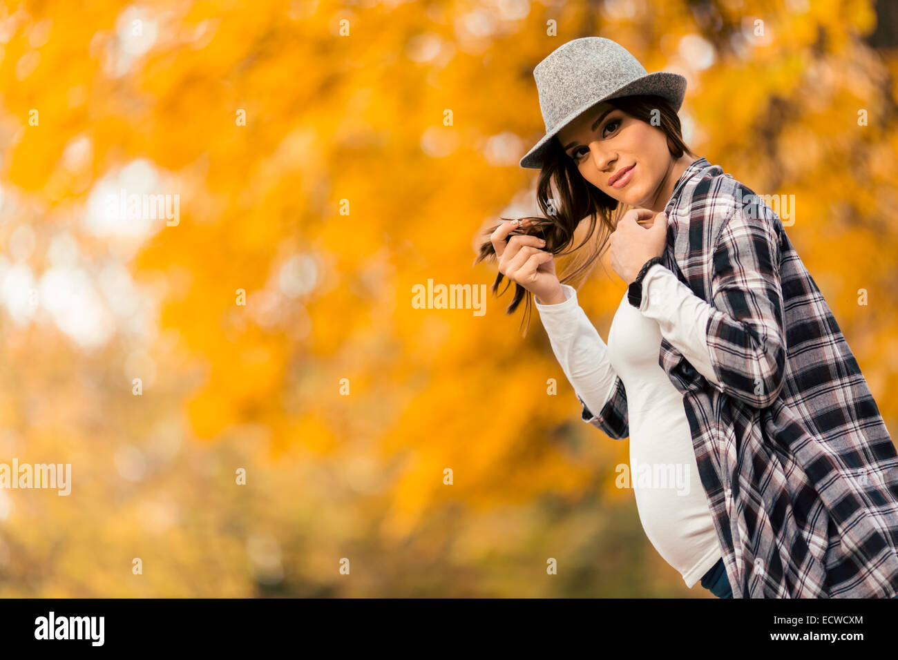 Young pregnant woman in the autumn park Stock Photo - Alamy