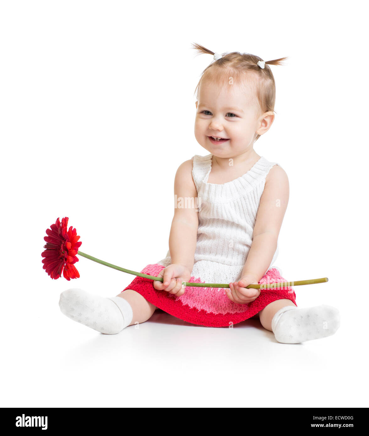 Adorable baby girl sitting with flower isolated Stock Photo
