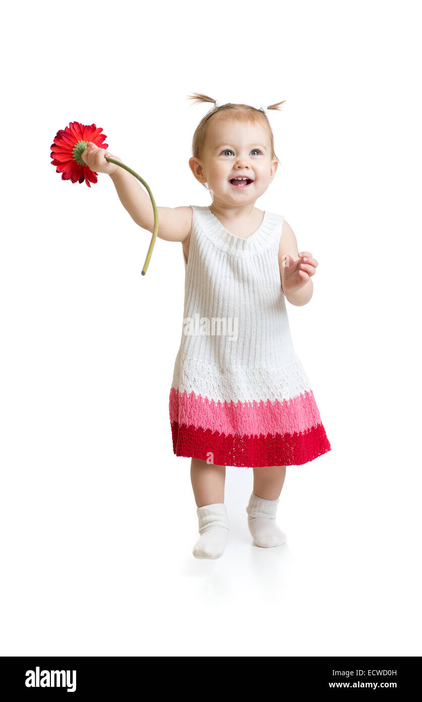 Adorable baby girl walking with flower isolated Stock Photo