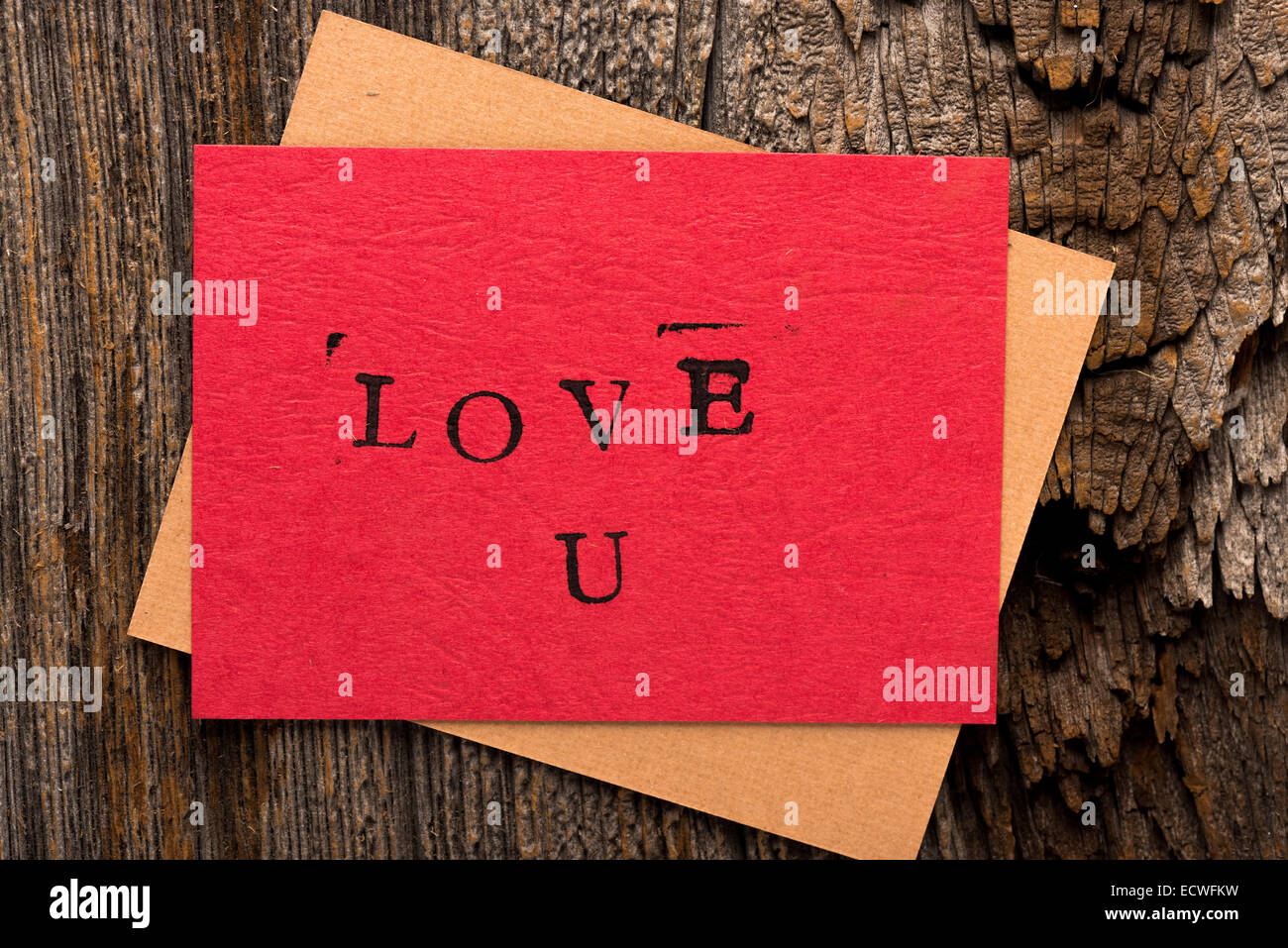 Handmade stamped valentine's day card with Love U stamped on it set on rustic wood with copy space Stock Photo