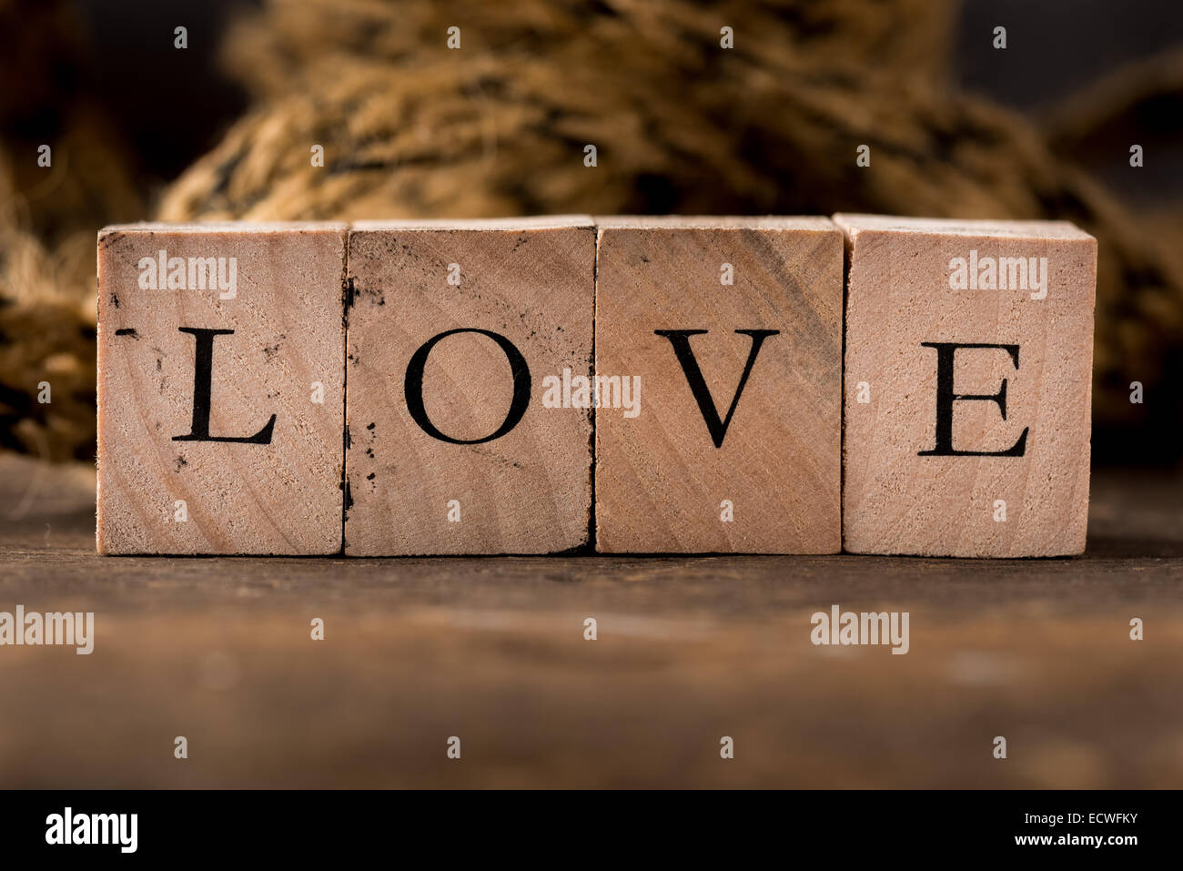 Stamping blocks with the word LOVE spelled out set on rustic wood Stock Photo