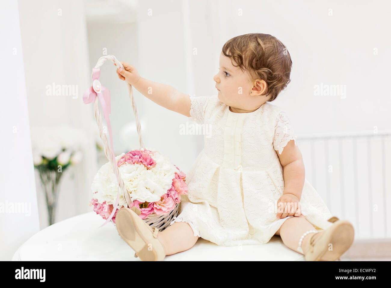Cute baby with flower basket Stock Photo