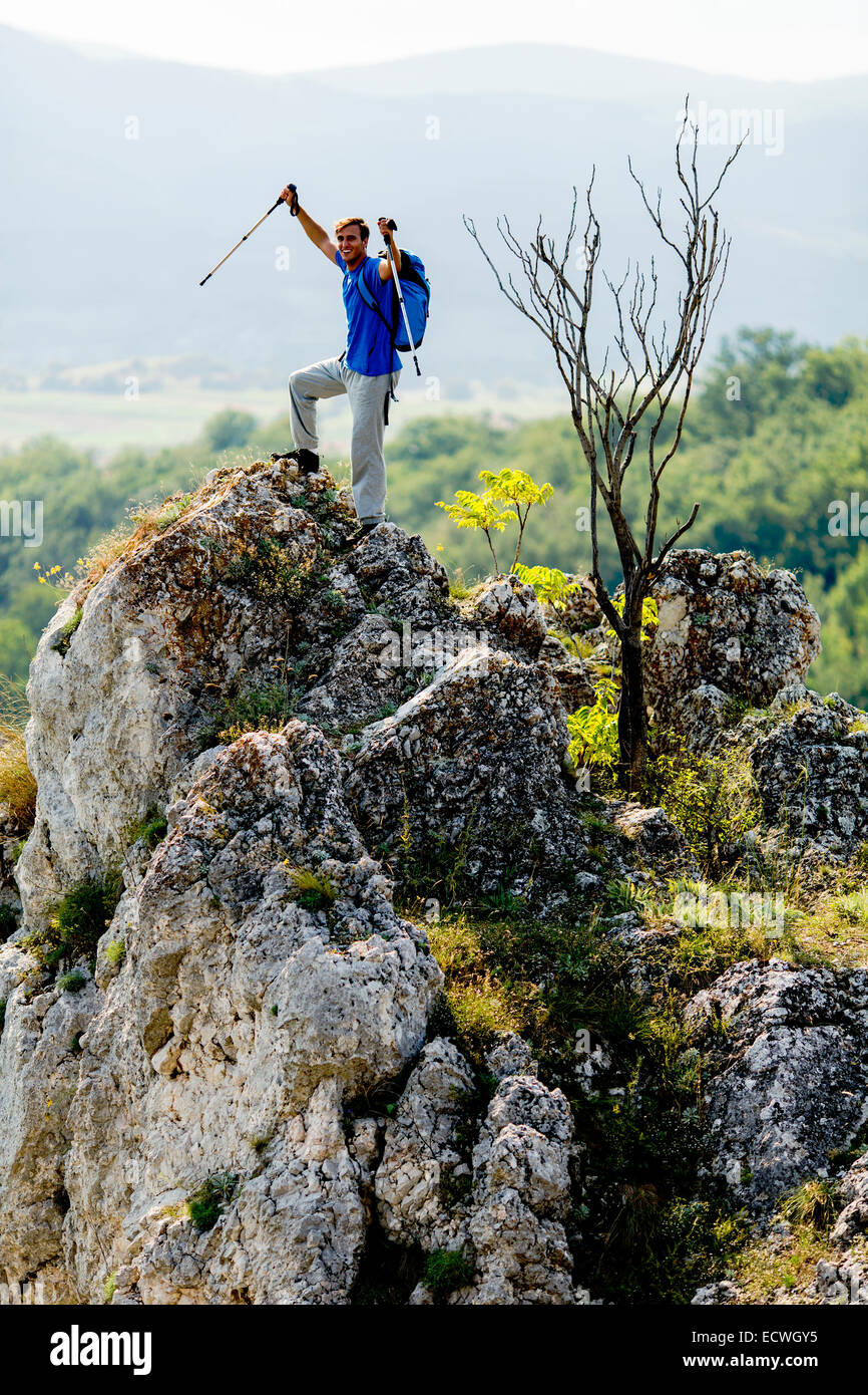 Young man hiking on the mountain Stock Photo - Alamy