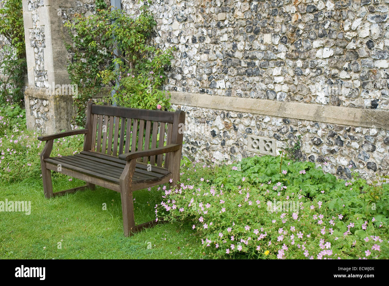 Bench at the wall of an old English church near London. Stock Photo