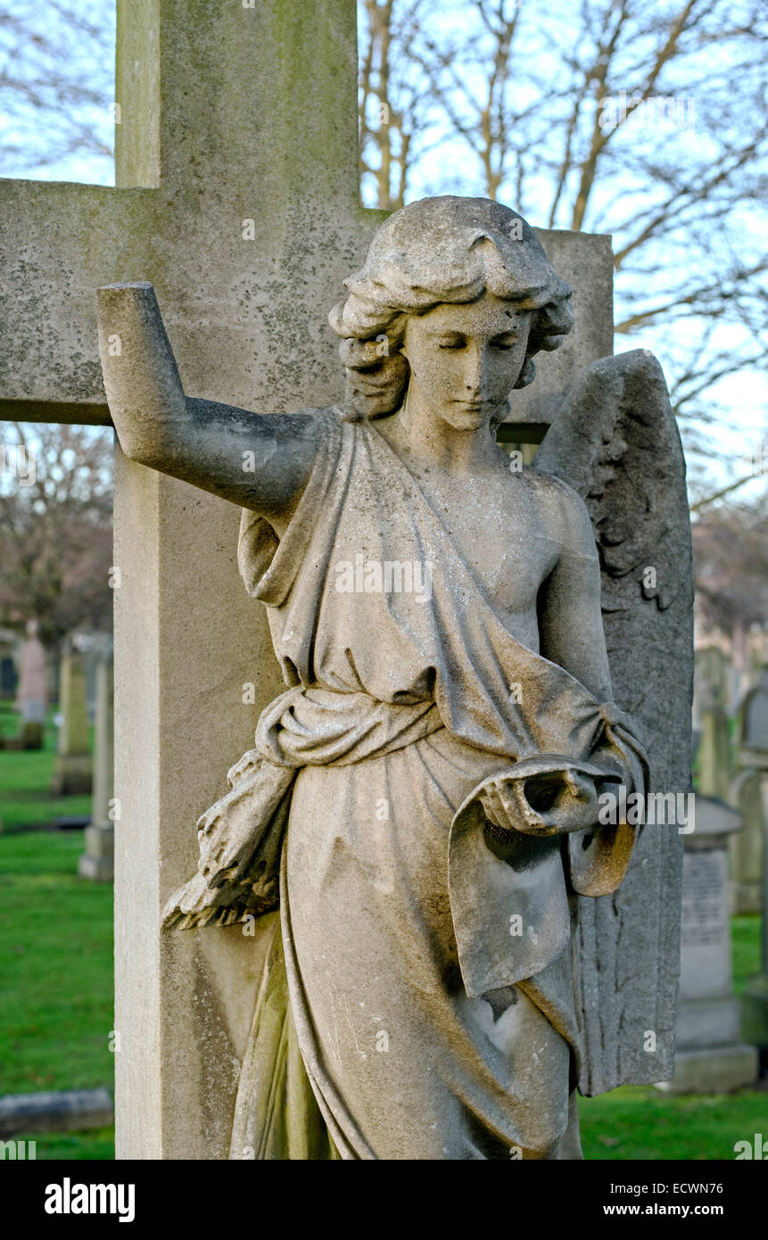 Figure of an angel with part of the arm broken off and a wing missing in the Grange Cemetery, Edinburgh, Scotland, UK. Stock Photo