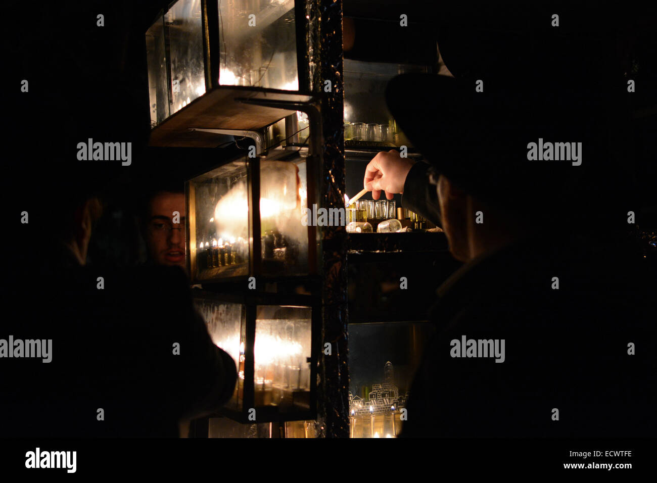 Religious Jew lighting Hanukkiah (a special candle set) during the 5th night of Hanukkah in the religious neighborhood of Nachlaot, Jerusalem. Credit:  Laura Chiesa/ Pacific Press/Alamy Live News Stock Photo