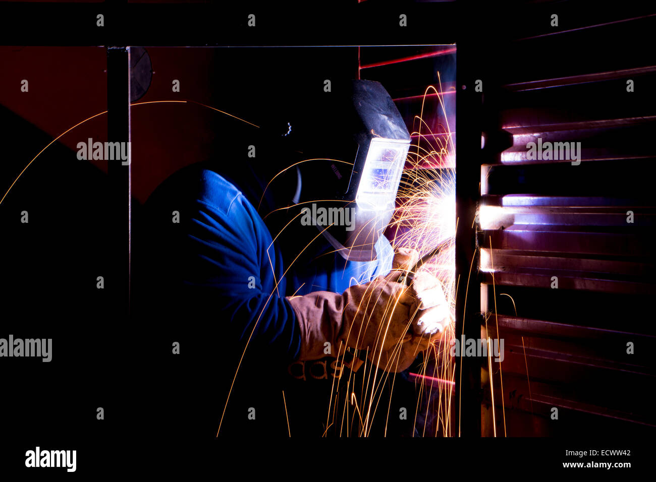 Man welding in horse trailer Stock Photo