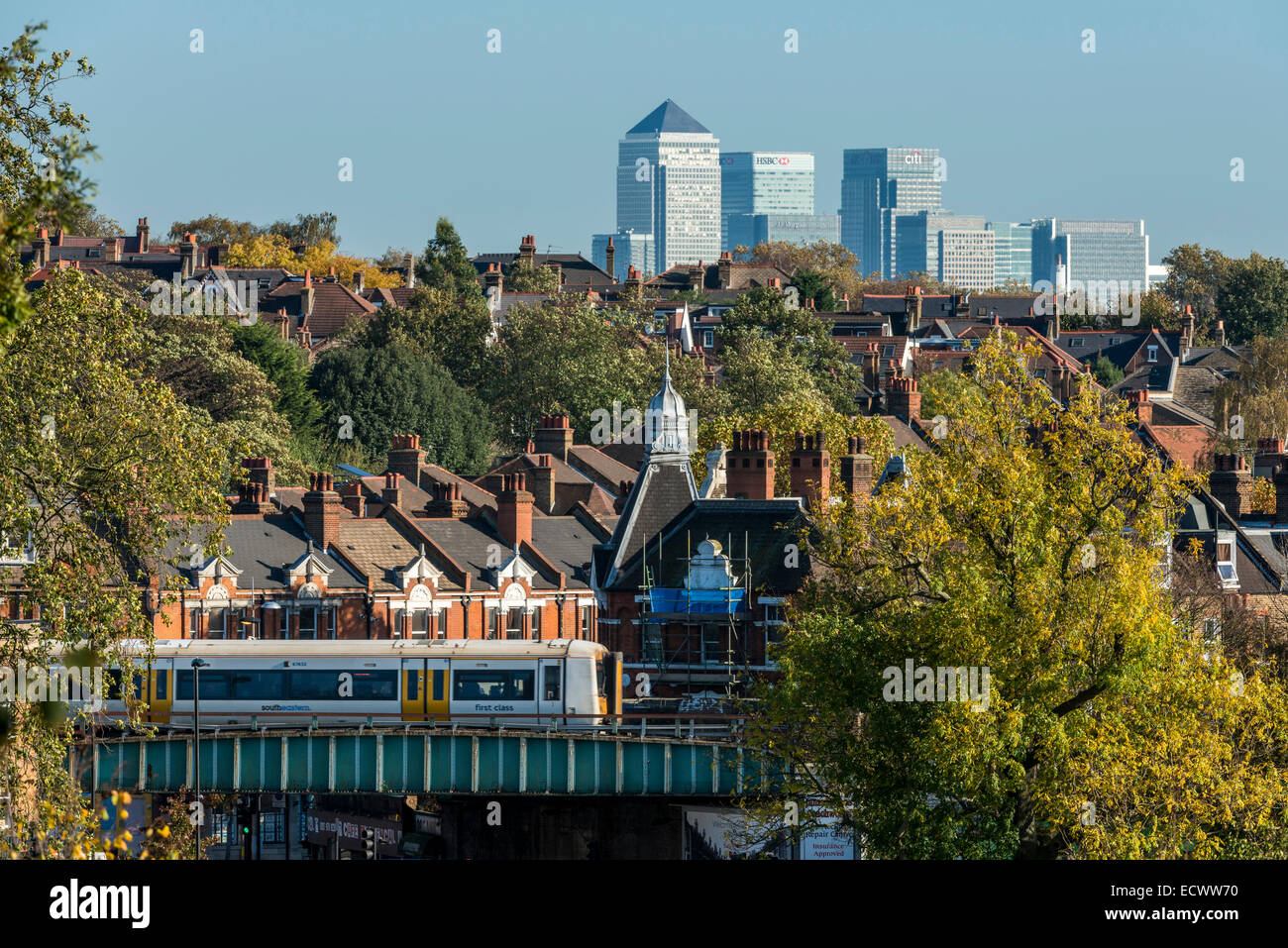 Views of Canary Wharf, the second financial district of London viewed across the rooftops of Herne Hill in South London Stock Photo