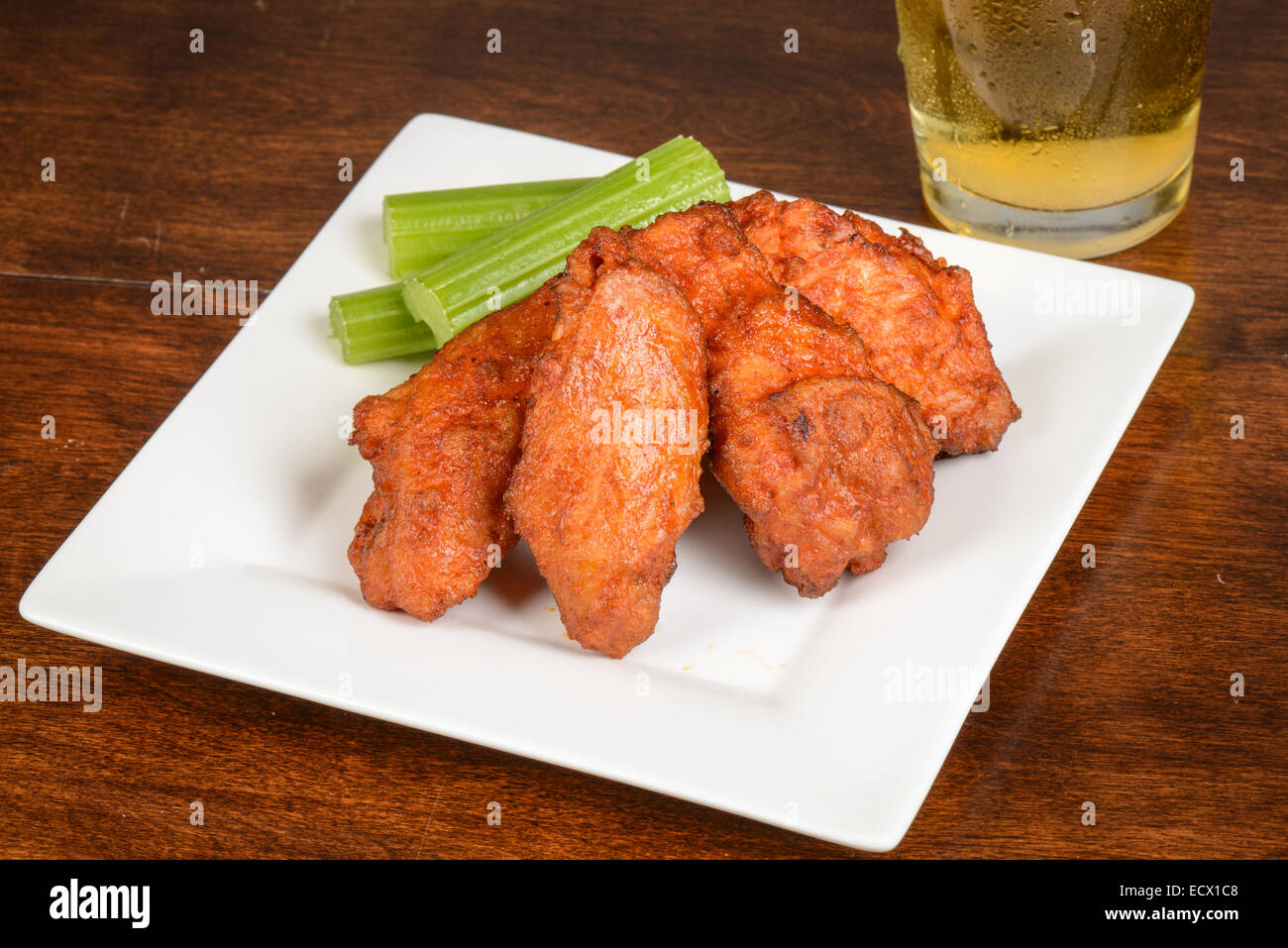 Chicken Buffalo Wings with Celery Sticks and Beer Stock Photo Alamy