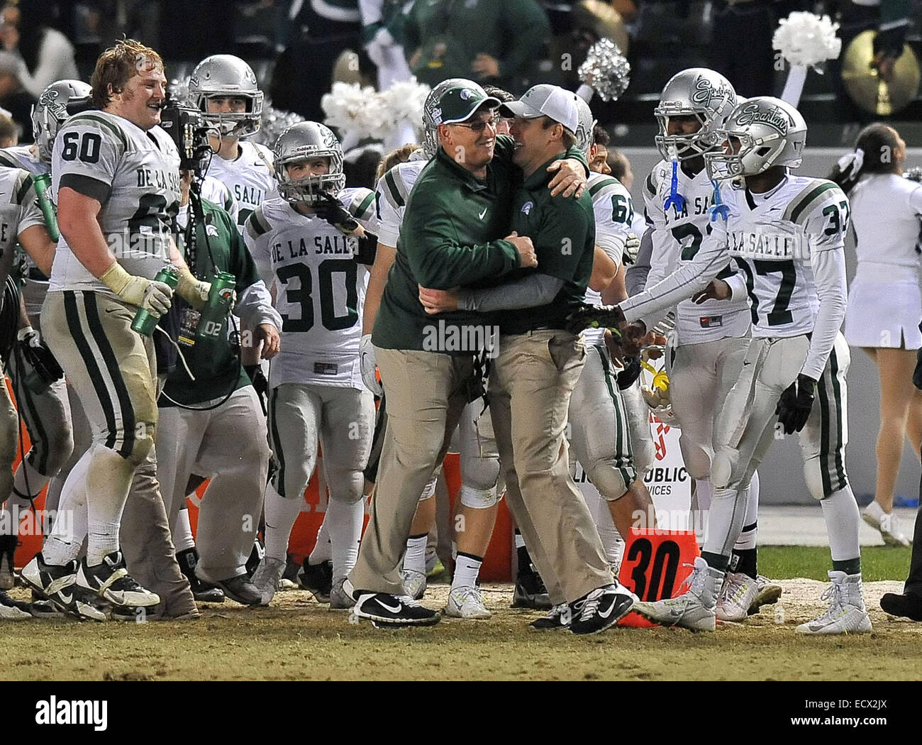 Carson, CA. 20th Dec, 2014. Concord De La Salle head coach Justin Alumbaugh celebrates on the sidelines in the closing seconds of the game as they win the CIF Open Division California State Football Championship game between Concord De La Salle and the Centennial Huskies at the Stub Hub Center in Carson, California.Concord De La Salle defeats the Centennial Huskies 63-42.Louis Lopez/CSM/Alamy Live News Stock Photo