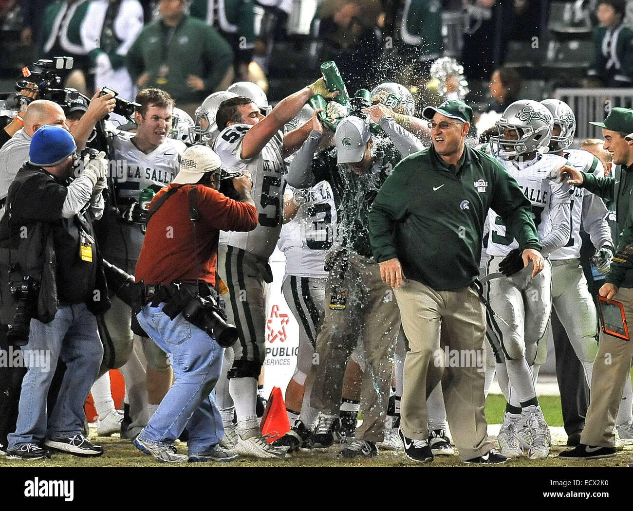 Carson, CA. 20th Dec, 2014. Concord De La Salle head coach Justin Alumbaugh is doused with water by his players as they celebrate on the sidelines in the closing seconds of the game as they win the CIF Open Division California State Football Championship game between Concord De La Salle and the Centennial Huskies at the Stub Hub Center in Carson, California.Concord De La Salle defeats the Centennial Huskies 63-42.Louis Lopez/CSM/Alamy Live News Stock Photo