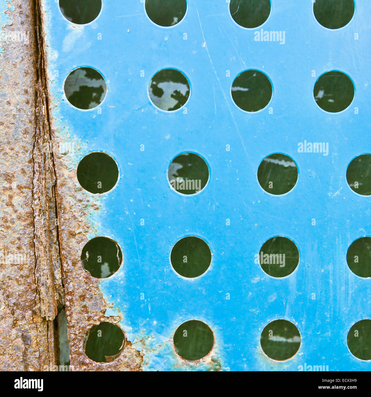Rusty blue fenestrated metal surface Stock Photo