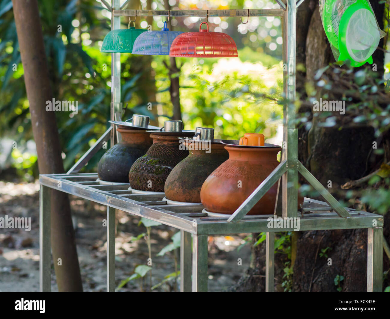 Clay containers containing drinking water for public consumption along a street in Yangon, Myanmar. Shallow depth of field. Stock Photo