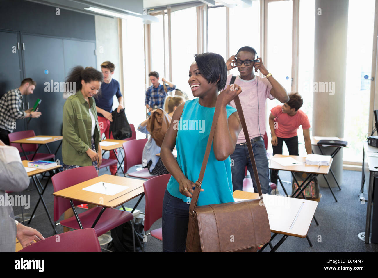 University students packing their bags and leaving classroom Stock