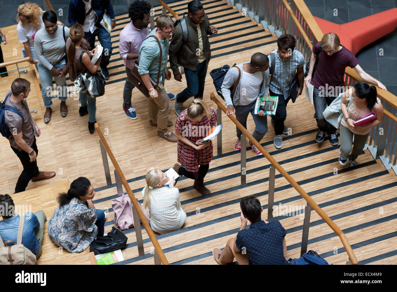 Elevated view of university students walking up and down stairs Stock Photo