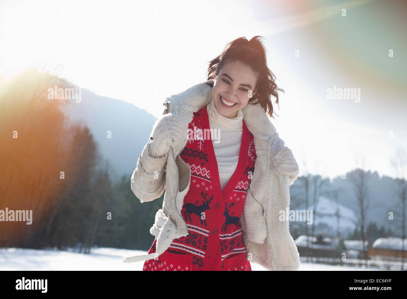 Smiling woman in snowy field Stock Photo - Alamy