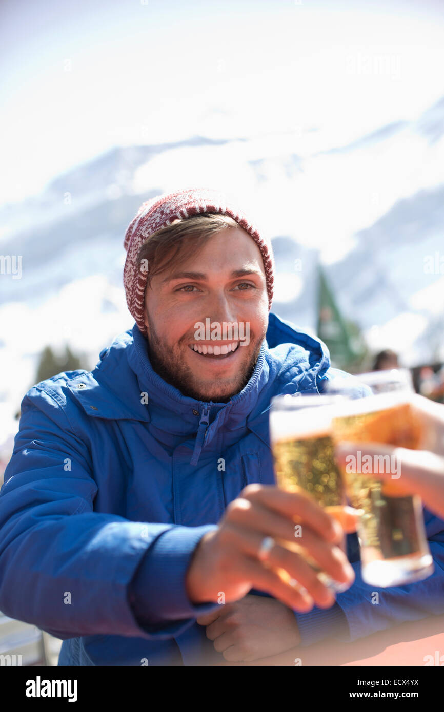 couple toasting beer glasses outdoors Stock Photo