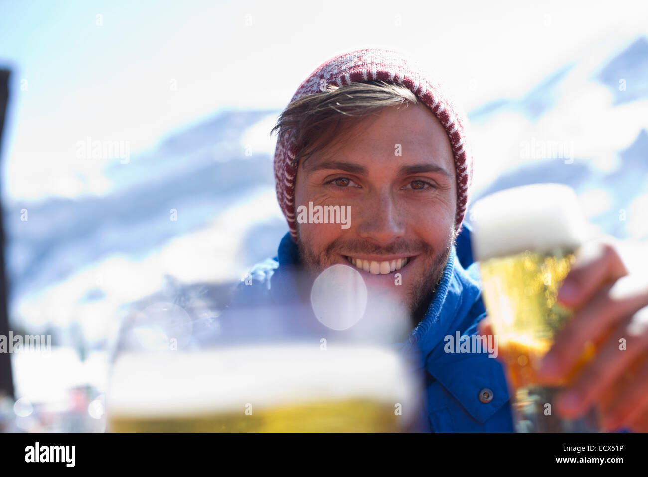 Portrait of man drinking beer outdoors Stock Photo