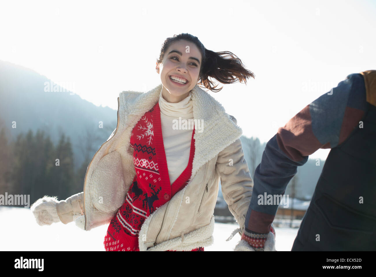 Couple running in snow Stock Photo