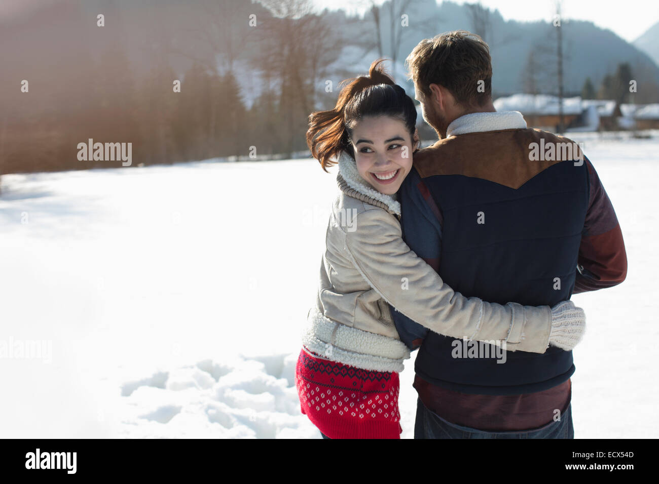 Happy couple walking in snow Stock Photo - Alamy