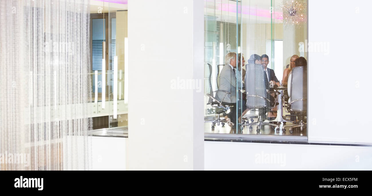 Distant view of business people having meeting in conference room Stock Photo