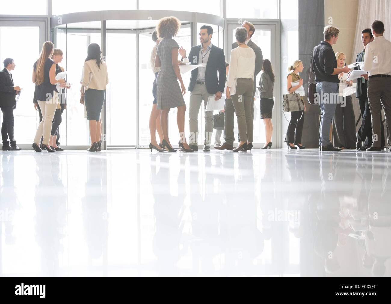 Group of business people standing and talking in office Stock Photo