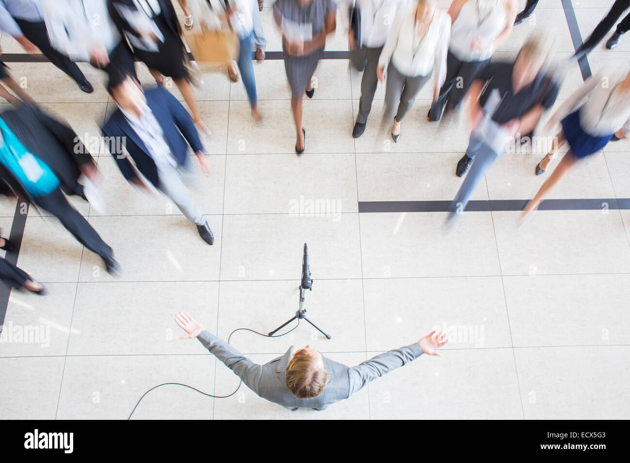 High angle view of business people walking towards colleague giving speech Stock Photo