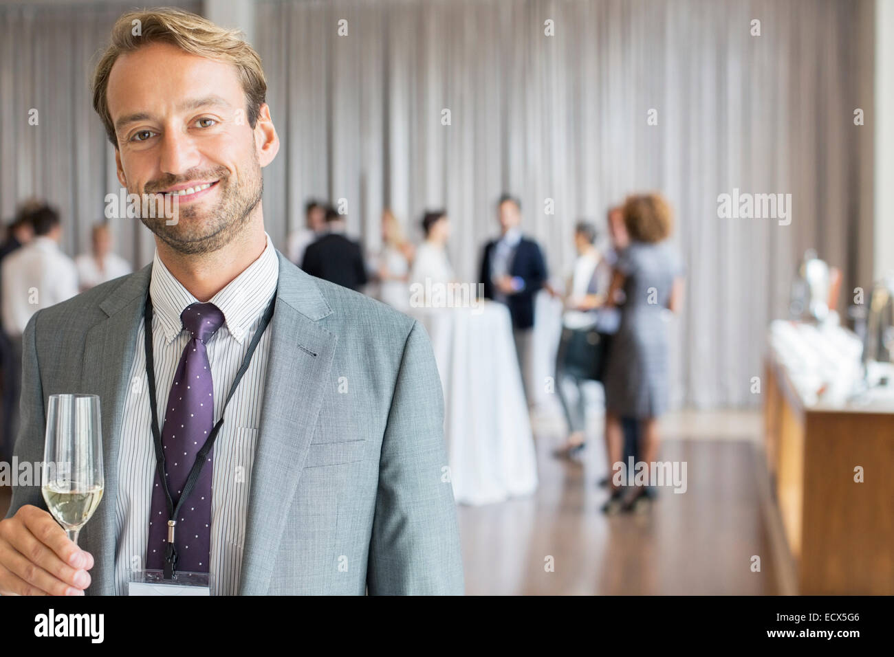 Portrait of smiling businessman holding champagne flute Stock Photo