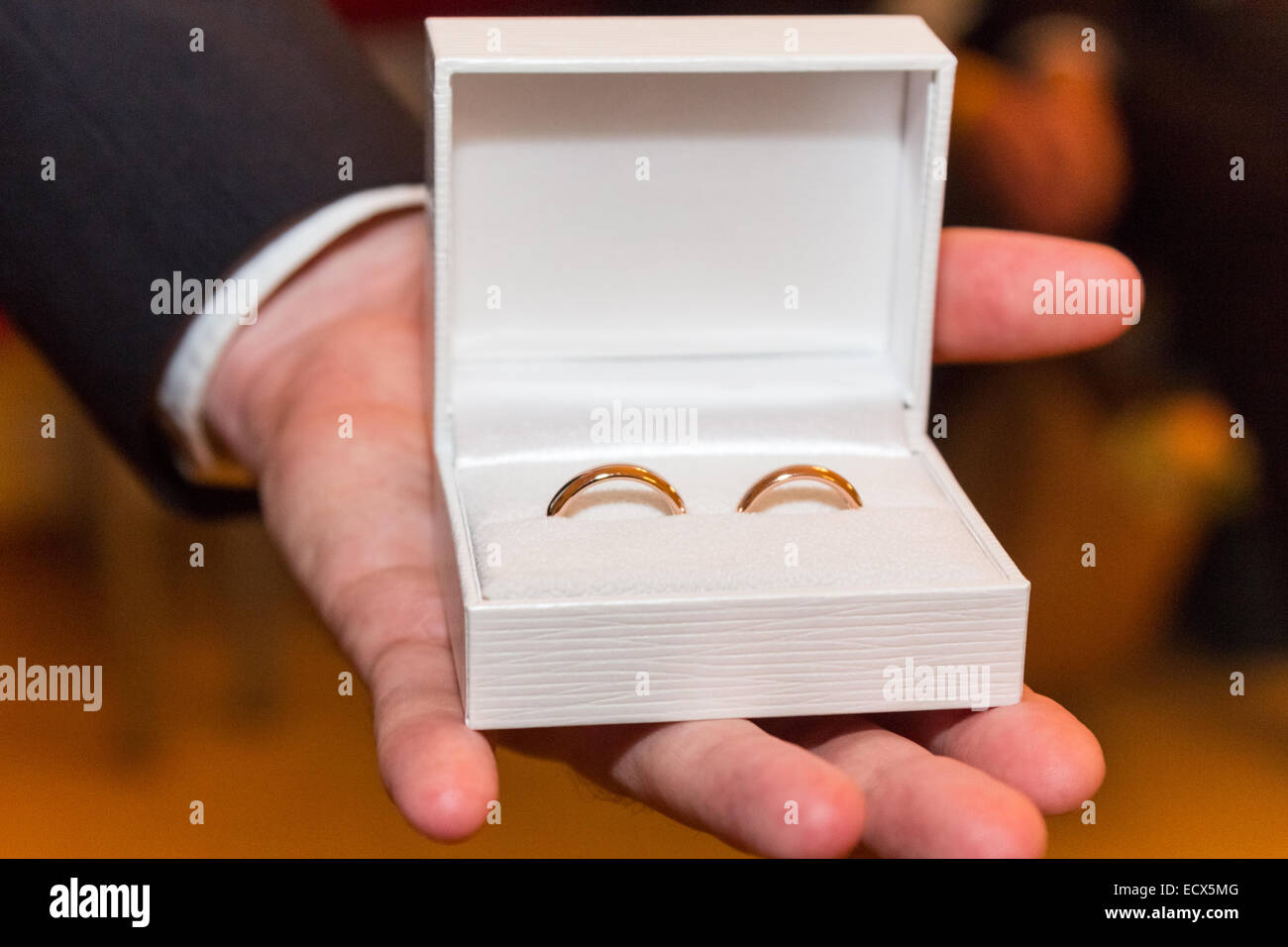 The ringbearer presents the rings at the wedding in a white box Stock Photo