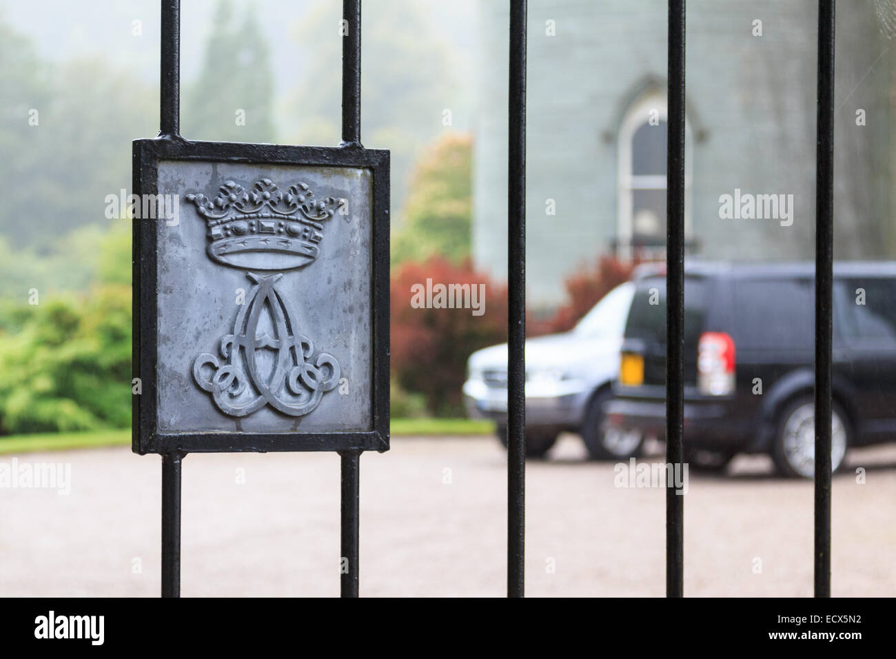 Fence of a gate to a luxury residence with crest in Scotland Stock Photo