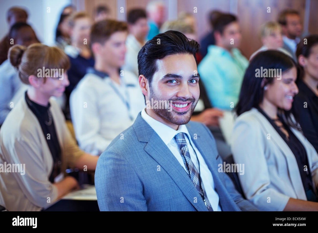 Smiling businessman sitting in conference room and looking at camera Stock Photo