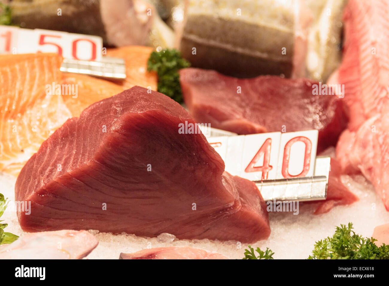 Raw tuna filet steak on a fish market in Venice next to salmon and other fish Stock Photo
