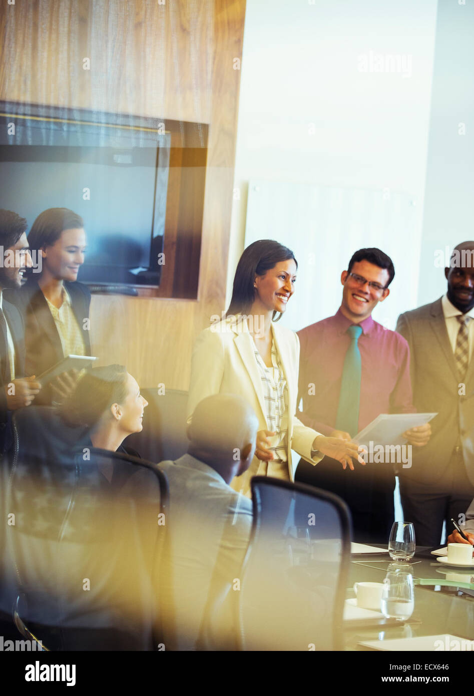 Group of business people smiling and discussing in conference room Stock Photo