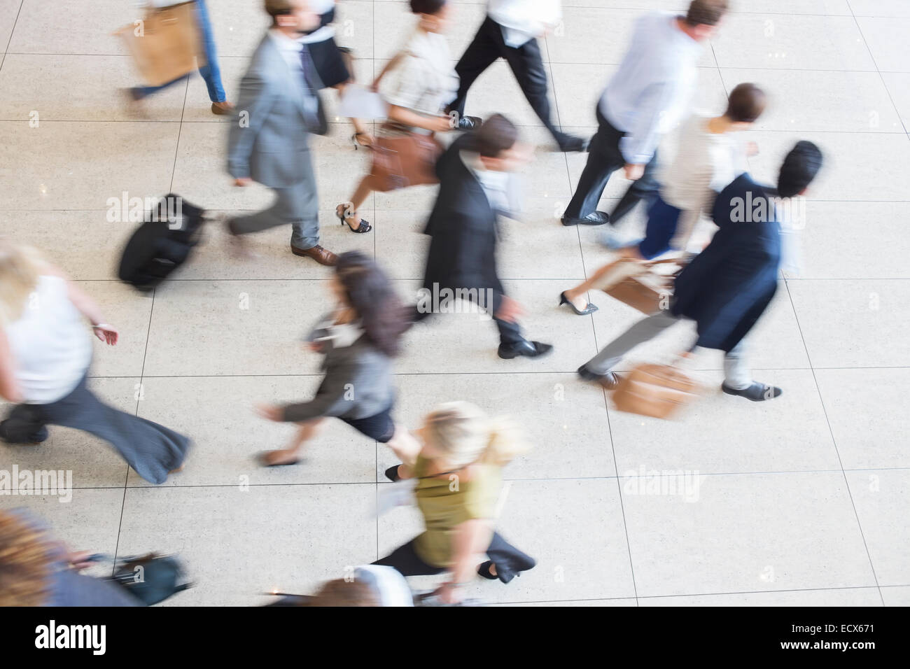 High angle view of business people walking in office on tiled floor Stock Photo