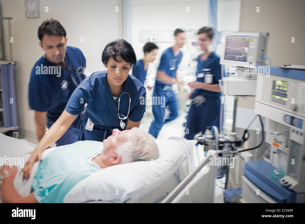 Two doctors preparing elderly patient before medical procedure Stock Photo